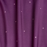 A close-up of Exes - Plum - Women's Polo fabric features small light pink embroidered x shapes, soft vertical folds, and a smooth texture with moisture-wicking properties for added comfort.