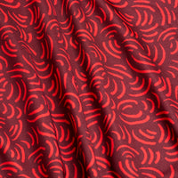 Close-up of the Arcs - Red - Women's Polo, featuring bright red curved lines and dashes on a deep red background. The gently folded fabric highlights its athletic fit and moisture-wicking properties.