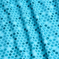 The Dots - Teal - Women's Polo showcases light blue fabric with dark blue oval dots in a repeating pattern. Its slightly wrinkled, textured surface is accented by soft shadows and offers moisture wicking for comfort.