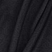 Close-up of Stealth Mode - Dark - Women's Polo fabric: very dark gray with fine vertical ribbing, soft folds, and subtle sheen. Lightweight and moisture-wicking for comfort; drapes naturally to create gentle shadows and highlights.