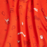 The Wingin' It - Orange - Women's Polo features bright orange fabric with small prints—chicken drumsticks, beer mugs, curly fries, and more—plus 