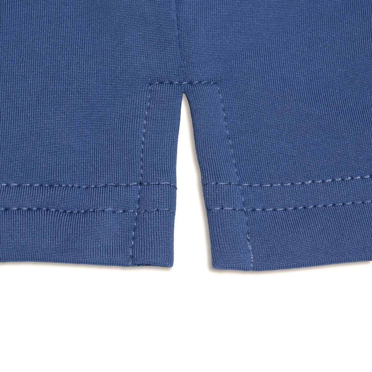 Close-up of the hem of the Cooler Blue - Hoodie, showing a vertical side slit at the seam with a visible double-stitched hem and textured, super stretchy fabric. The slit creates a small opening at the bottom edge, enhancing comfort and mobility.