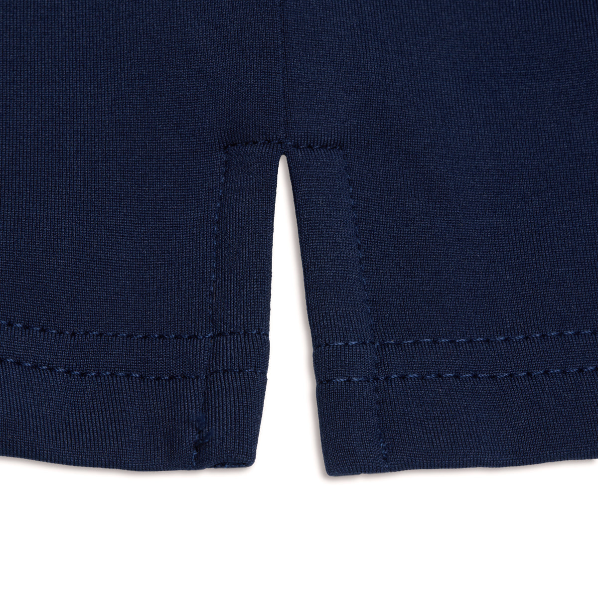 Close-up of the hem on the Navy - Hoodie, showcasing navy blue cotton knit fabric with two parallel stitched lines. The hem features a small, centered slit at the bottom edge that creates two symmetrical flaps. Designed for comfort and enhanced with moisture-wicking properties, the hoodie’s fabric is displayed against a plain white background.