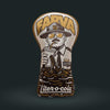 A plush toy shaped like a bottle opener cover features a cartoon police officer labeled FARVA drinking a large soda, with the text liter-o-cola and brown soda splashing out beneath. The colors are mainly brown, gold, and cream.
