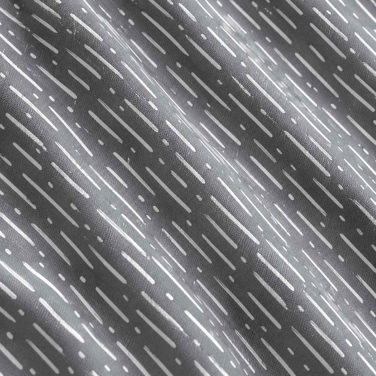 Here’s the revised sentence using your product data: A close-up, angled view of the Drizzle Dreams - Women’s Polo showcases its dark grey fabric, adorned with a repeating pattern of white vertical dashed lines composed of alternating long and short dash-like strokes. Gentle folds and soft shadows accentuate the material’s depth and texture. Designed for an athletic fit, this polo features UPF 50 protection as well as moisture-wicking properties.