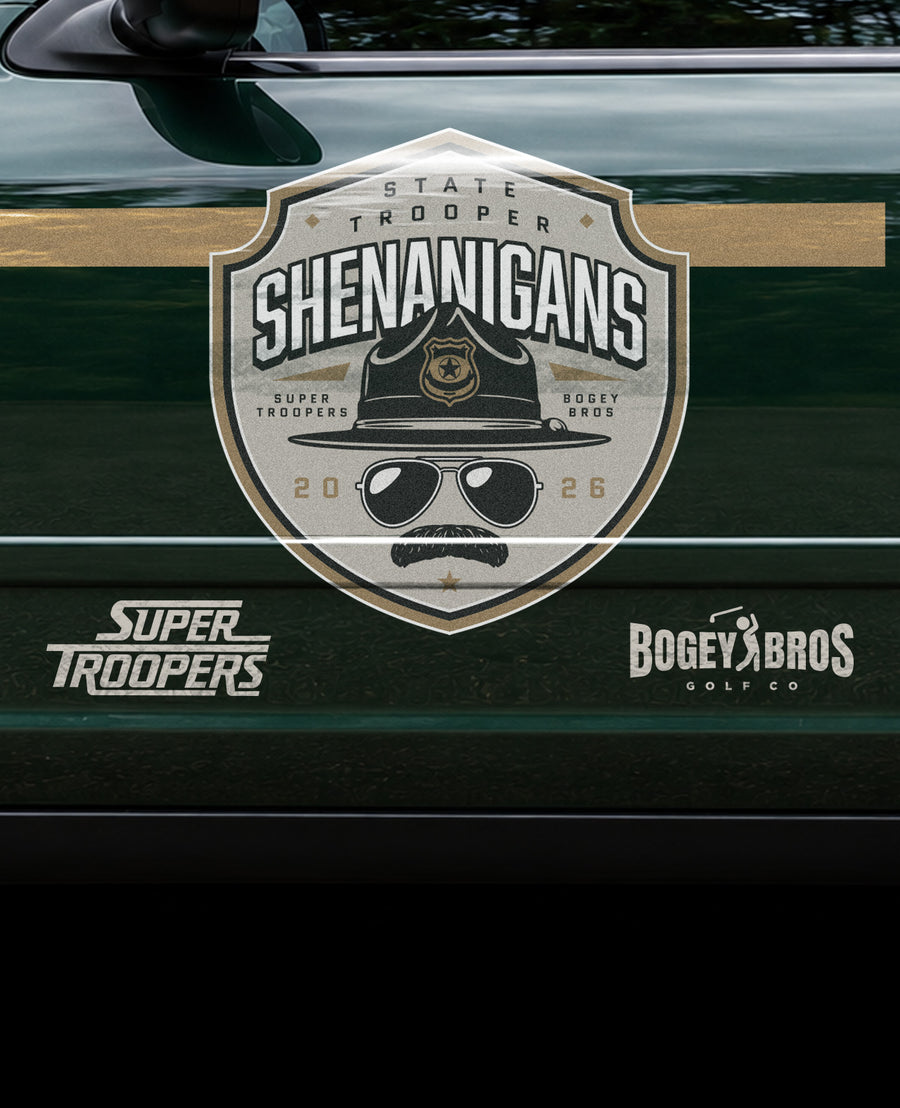 Side of a dark green police car with a large badge logo reading Shenanigans featuring a mustache and sunglasses, surrounded by sponsors Super Troopers and Bogey Bros Golf Co. Text also reads Vermont State Troopers, Unit 91, and Vermont State Police..
