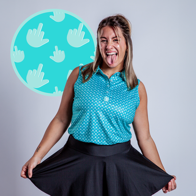 A woman wearing the Birdie Finger - Women's Polo smiles playfully, holding out her black skirt. Behind her, a turquoise circle shows several white hand icons with raised middle fingers.