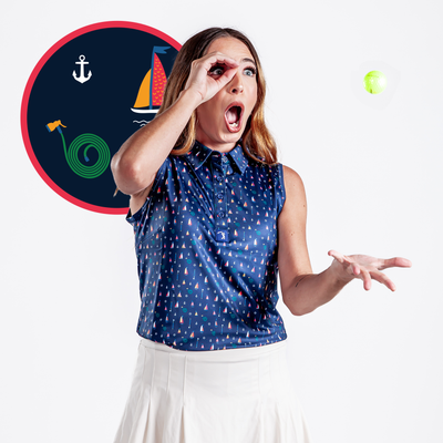 A surprised woman in the "Boats and Hose - Women's Polo," a sleeveless navy shirt with sailboat prints, tosses a tennis ball with her right hand while circling her left hand over her eye. A backdrop shows a sailboat, anchor, and green swirl on a navy circle.